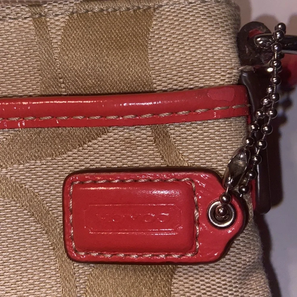 Tan and burnt orange Coach crossbody bag.